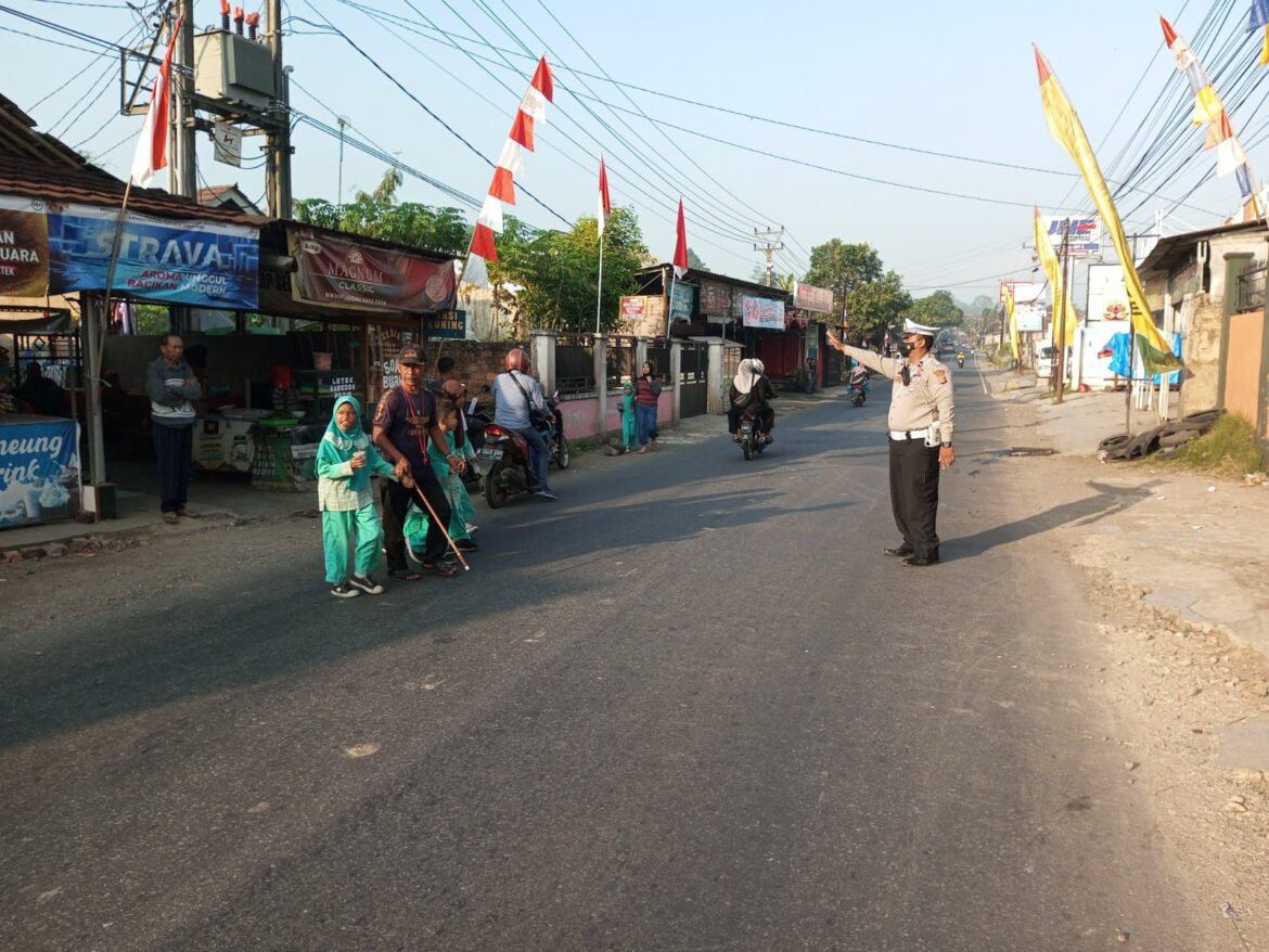 Kanit lantas Polsek Gunungguruh Beri Bantu Anak Sekolah Menyeberang Jalan